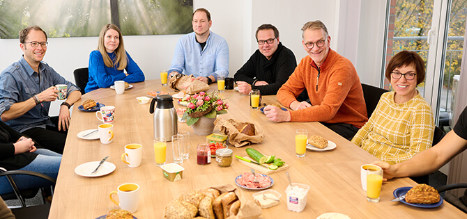 Lunch break in the team: employees gathered at the dining table